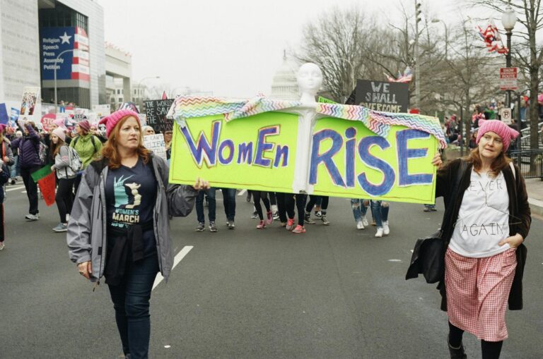 Participants in the Women's March carry a 'Women Rise' banner in Washington, DC. Empowering activism.